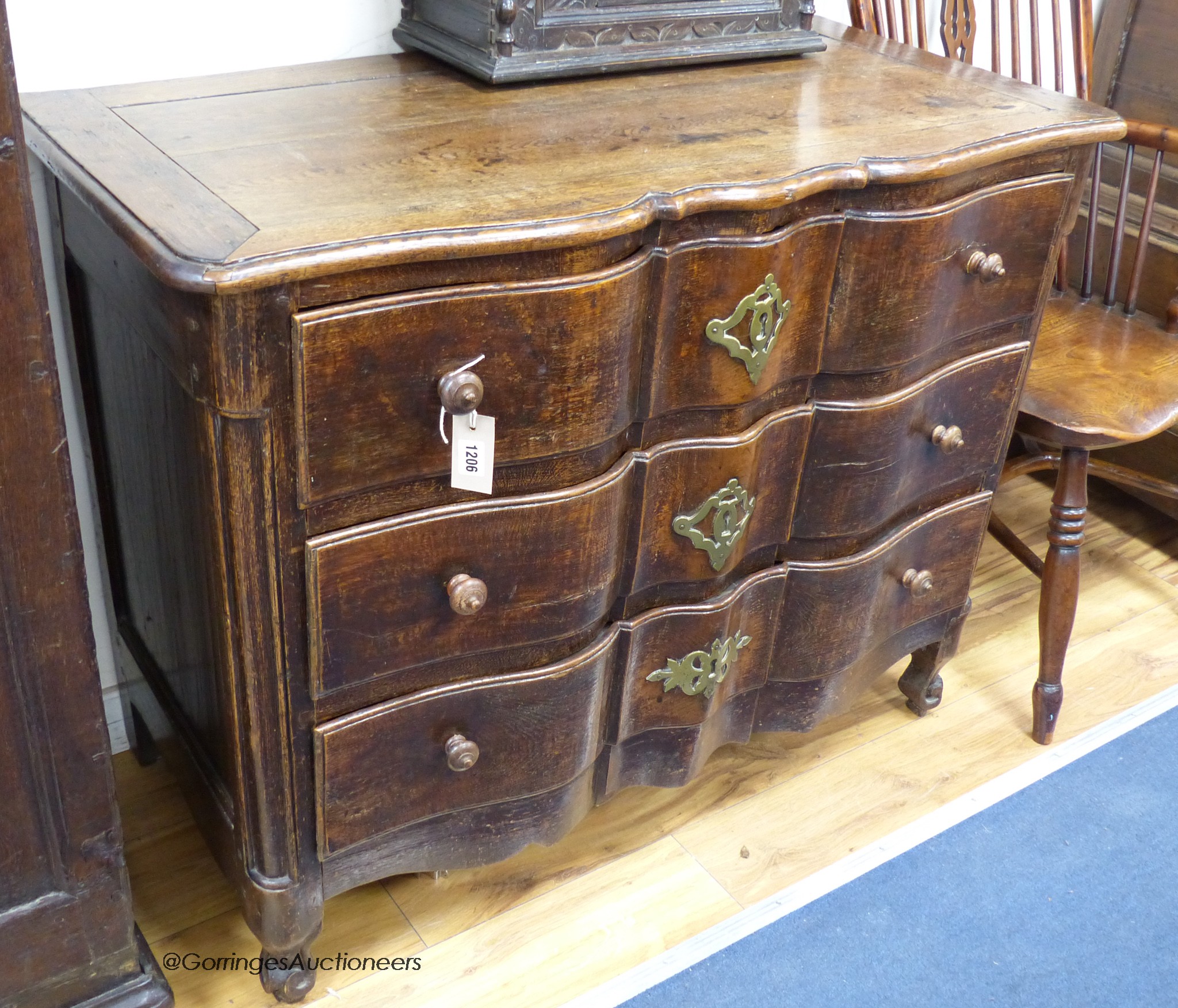 An 18th century Louis XV provincial oak and chestnut ‘Cupid’s bow fronted’ commode, width 104cm, depth 53cm